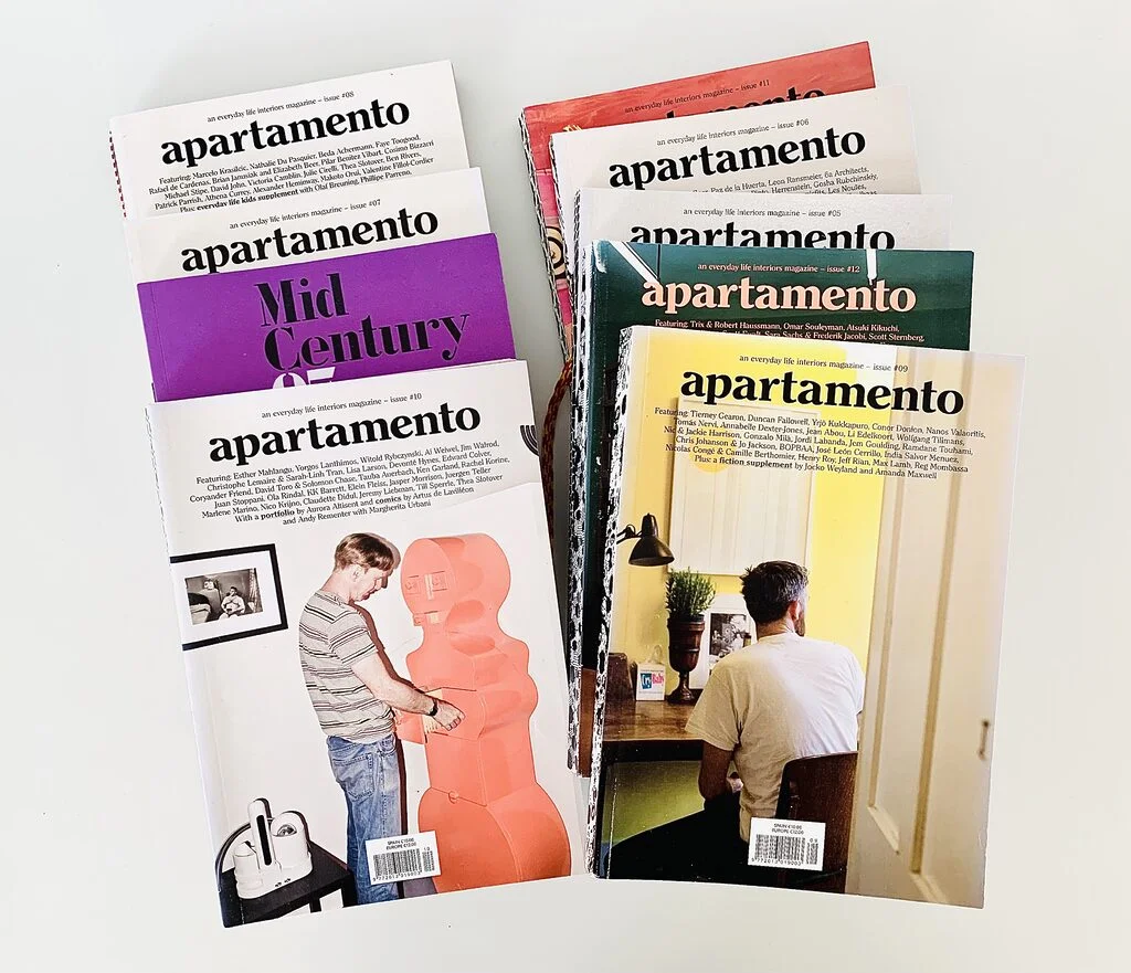 Photo of two piles of Apartamento magazines spread out neatly on a white table.