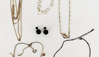 Photo of six pieces of costume jewelery on a white table