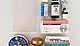 Photo of a tidy arrangement of items which were decluttered from the bathroom medicine chest. The apothecary items are arranged neatly on a white table and photographed from above. We can see a packet of expired aspirin, some zinc salve, tiger balm, a plaster and assorted drops and gels.