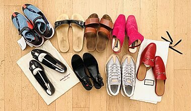 Photo of eight pairs of shoes laid out neatly on a clean oak parquet floor. The shoes include trainers from Nike, sandels, wedges, mules from Gucci, and a pair of Ferragamo ballerinas. They were all sorted out during a 30 day declutter challenge.