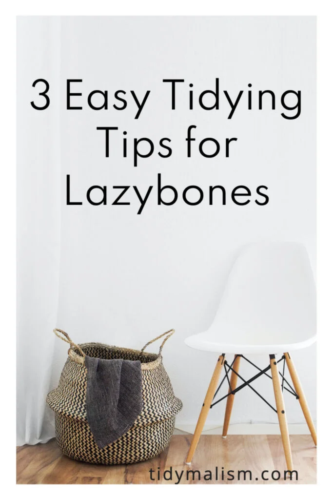 The three best tidying tips include getting rid of things you don't like. Photo of a white Eames chair with wood legs, and a simple basket next to it.