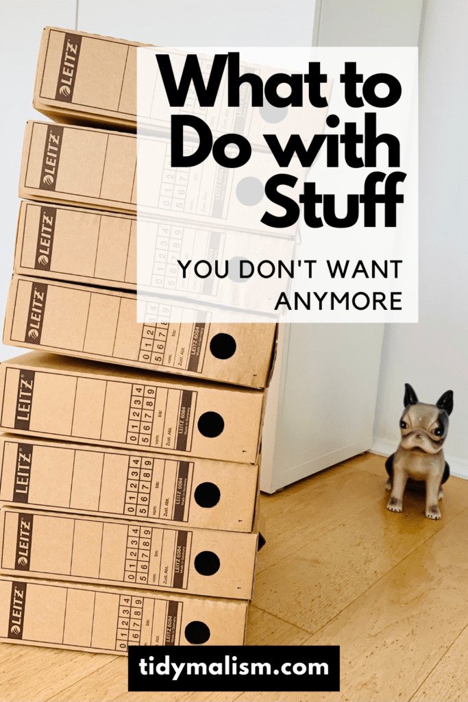 Photo of a stack of cardboard archive file storage boxes sorted out during a decluttering challenge. Caption reads: What to do with stuff you don't want anymore.
