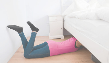 Image showing lady lying on floor on her belly, digging under her bed. Caption reads Why Under Bed Storage is a Bad Idea and post explains why storing things under the bed is dirty, causes dust, mildew and mould, and blocks air circulation to the mattress.