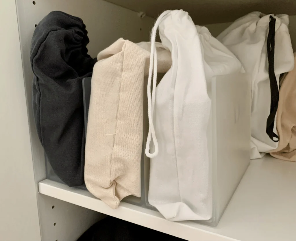 A file holder being used to organise luxury handbags in the closet.
