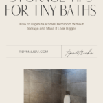 Photograph of a very minimalist bathroom tiled in large-format, concrete grey tiles on the walls and floor. The bidet and toilet are wall mounted and white porcelain, with the plumbing integrated in the wall. Fixtures are clean and modern looking in stainless steel. Caption reads: Storage tips for tiny baths: how to organize a small bathroom and make it look bigger.