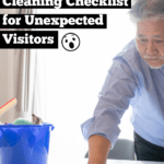 Middle-aged Asian man with grey beard and hair, wearing light blue shirt and trousers. He looks a bit worried as he wipes down a tabletop with a cleaning rag. To his right is a bright blue cleaning bucket with other cleaning utensils. Caption reads: 30-minute speed cleaning checklist for unexpected visitors.