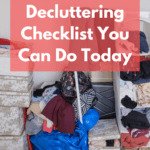 Photo of a heap of items that appear to have been decluttered and piled on the floor. Items include clothing, boxes of smaller clothing items, a belt, and a large blue garbage bag full of yet more clothing that's been sorted out. Caption reads: A–Z decluttering checklist you can do today.