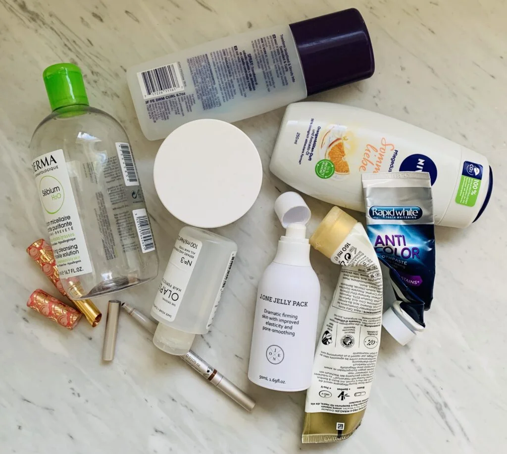 Photo of empty beauty products used up over the course of one quarter of a low buy challenge. Getting good low buy year results means using up the products you already have at hand.