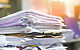 Huge messy stack of papers you can get rid of by going paperless at home.