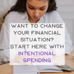 Young woman with long dark hair tied back reviewing her budget, spending and personal finances.