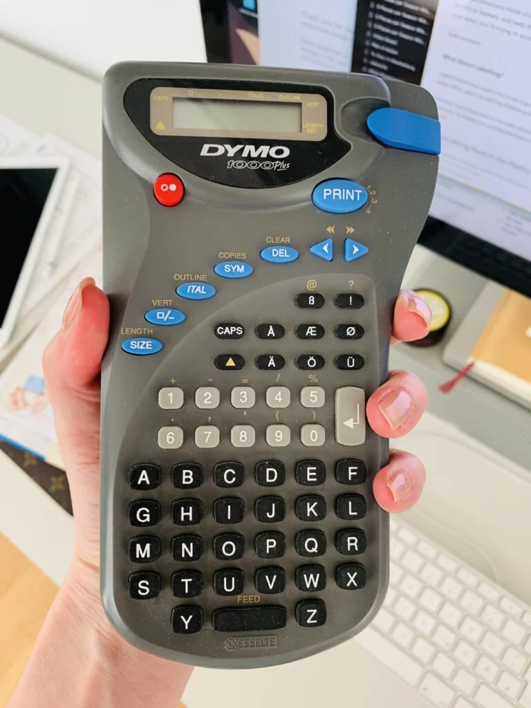 Older model of a hand-held label maker from Dymo.