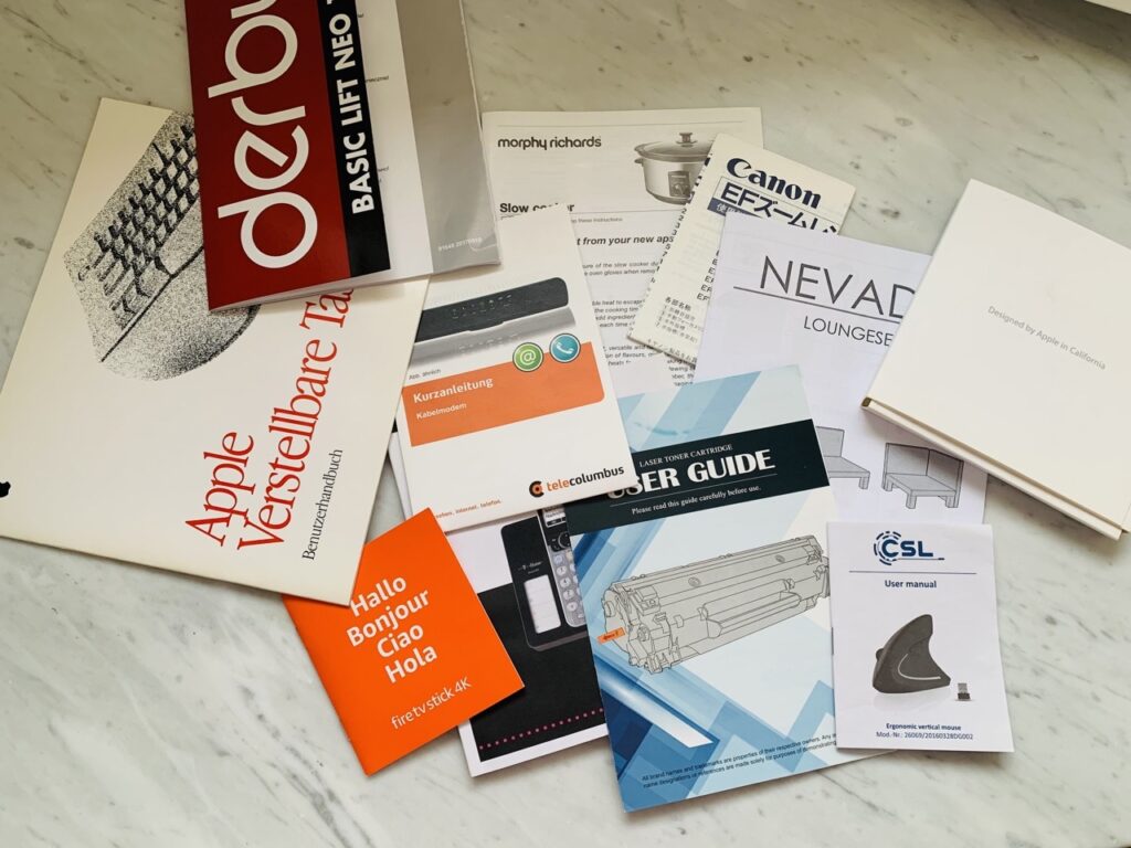 An assortment of instruction manuals decluttered during a 30 day minimalism game.
