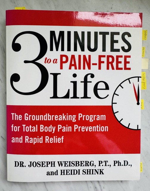 A book, 3 minutes to a pain free life by Dr Weisberg, lying on the kitchen counter.