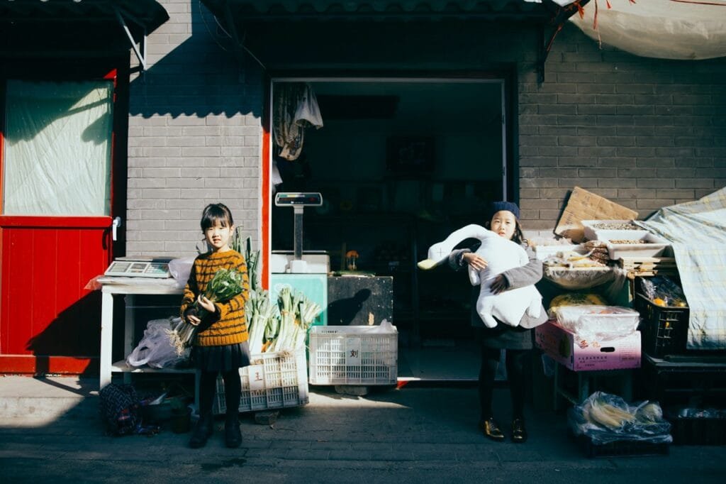 Two kids preparing for a garage sale