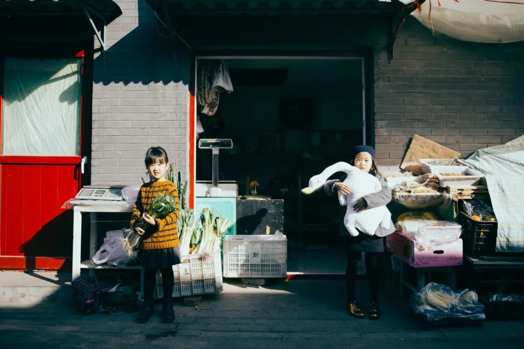 Two kids preparing for a garage sale