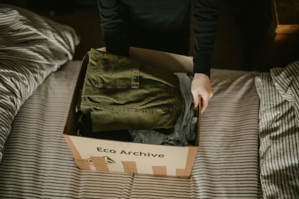 packing up clothes in a box for moving day