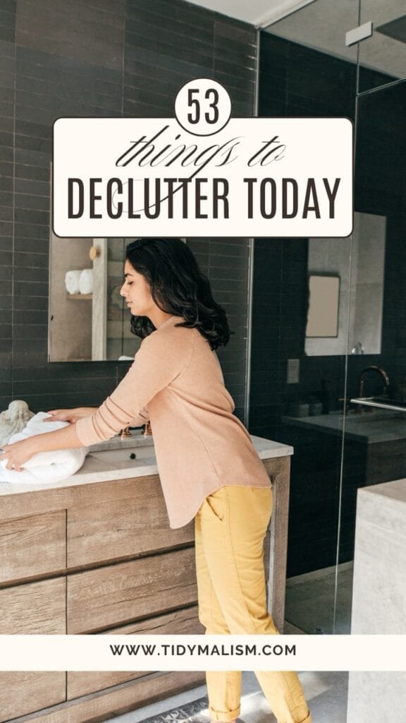 woman tidying up her bathroom while working through a 53 things to declutter today checklist